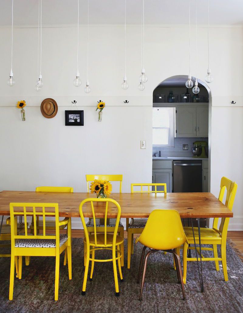 Yellow Mismatched Chairs around Reclaimed Table on Hairpin Legs Grain and Frame Yellow Mismatched Chairs around Reclaimed Table on Hairpin Legs - Grain and Frame